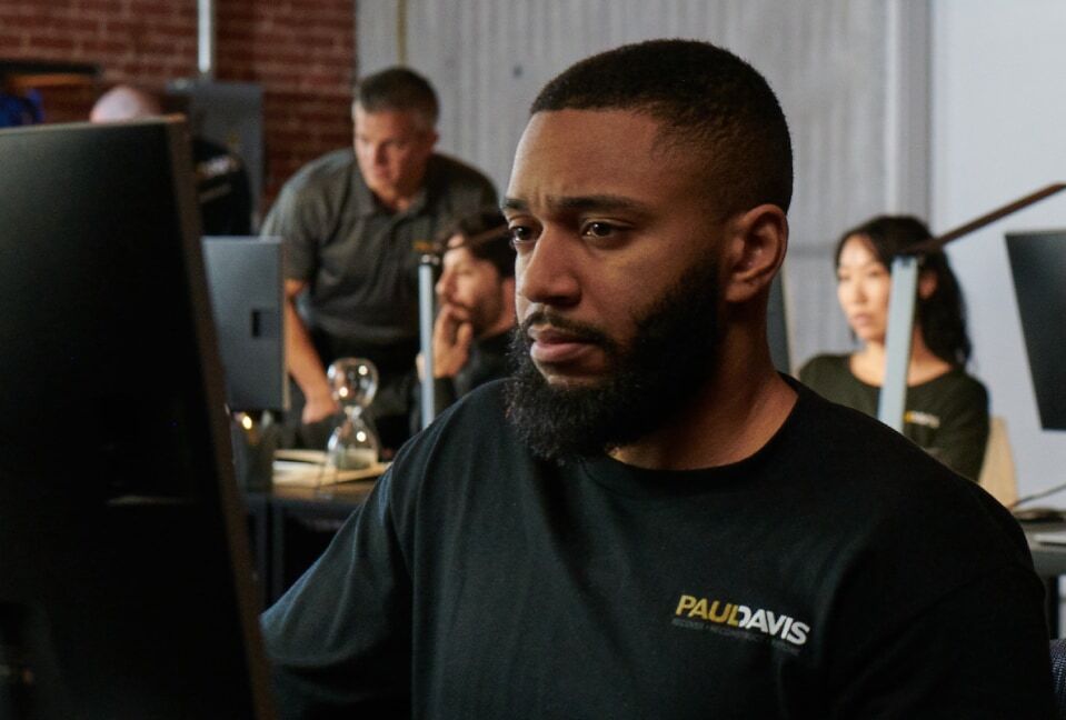 Paul Davis Restoration staff member working at a computer in the office